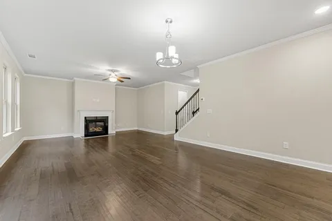 a view of empty room with wooden floor and fireplace