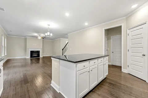an entryway with chandelier and wooden floor