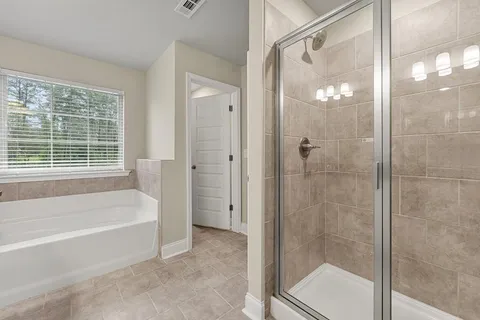 a bathroom with a bathtub and a shower