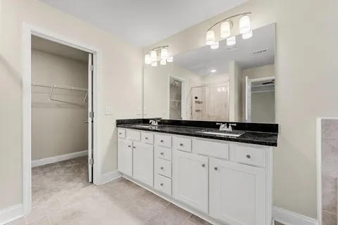 a bathroom with double sink and a mirror