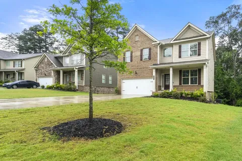 a front view of a house with a yard