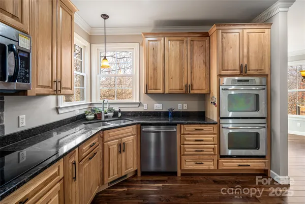 a kitchen with stainless steel appliances a stove sink and microwave