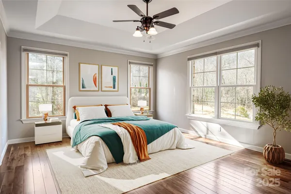 a spacious bedroom with a bed and a large window with wooden floor