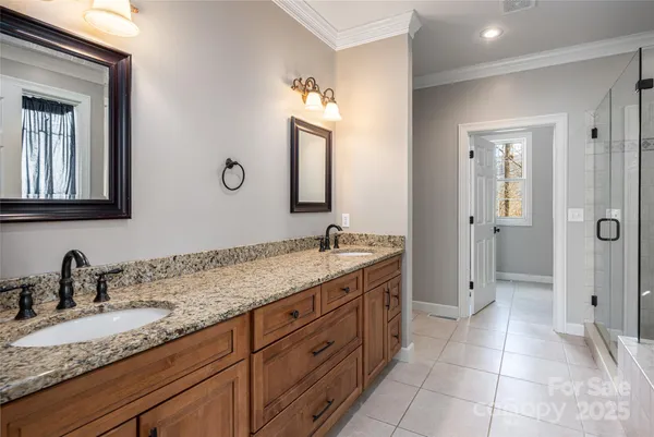 a bathroom with a granite countertop sink mirror and double