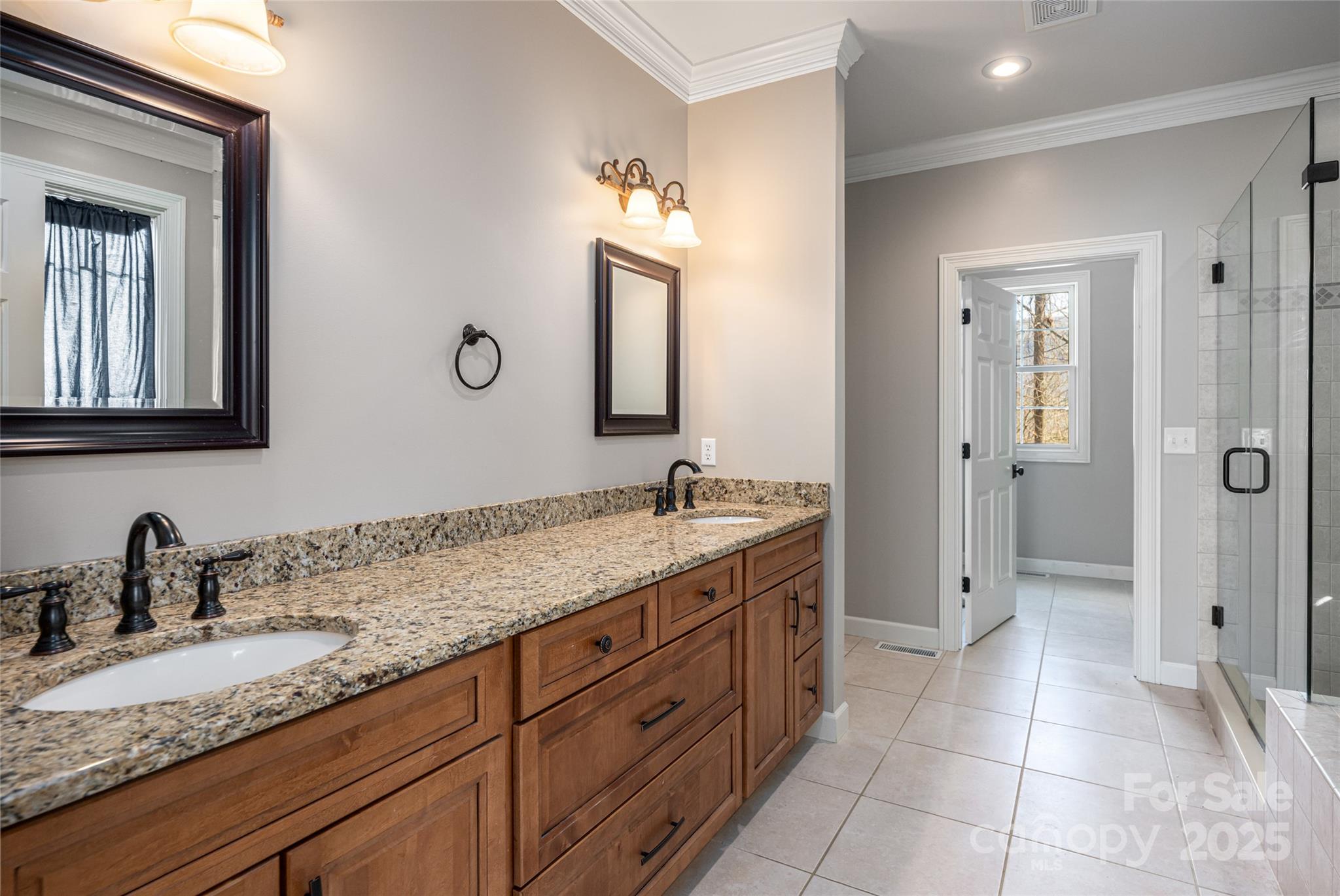 98 Sovereign Lane Fairview, NC 28730 - Photo 18 of 42 a bathroom with a granite countertop sink mirror and double