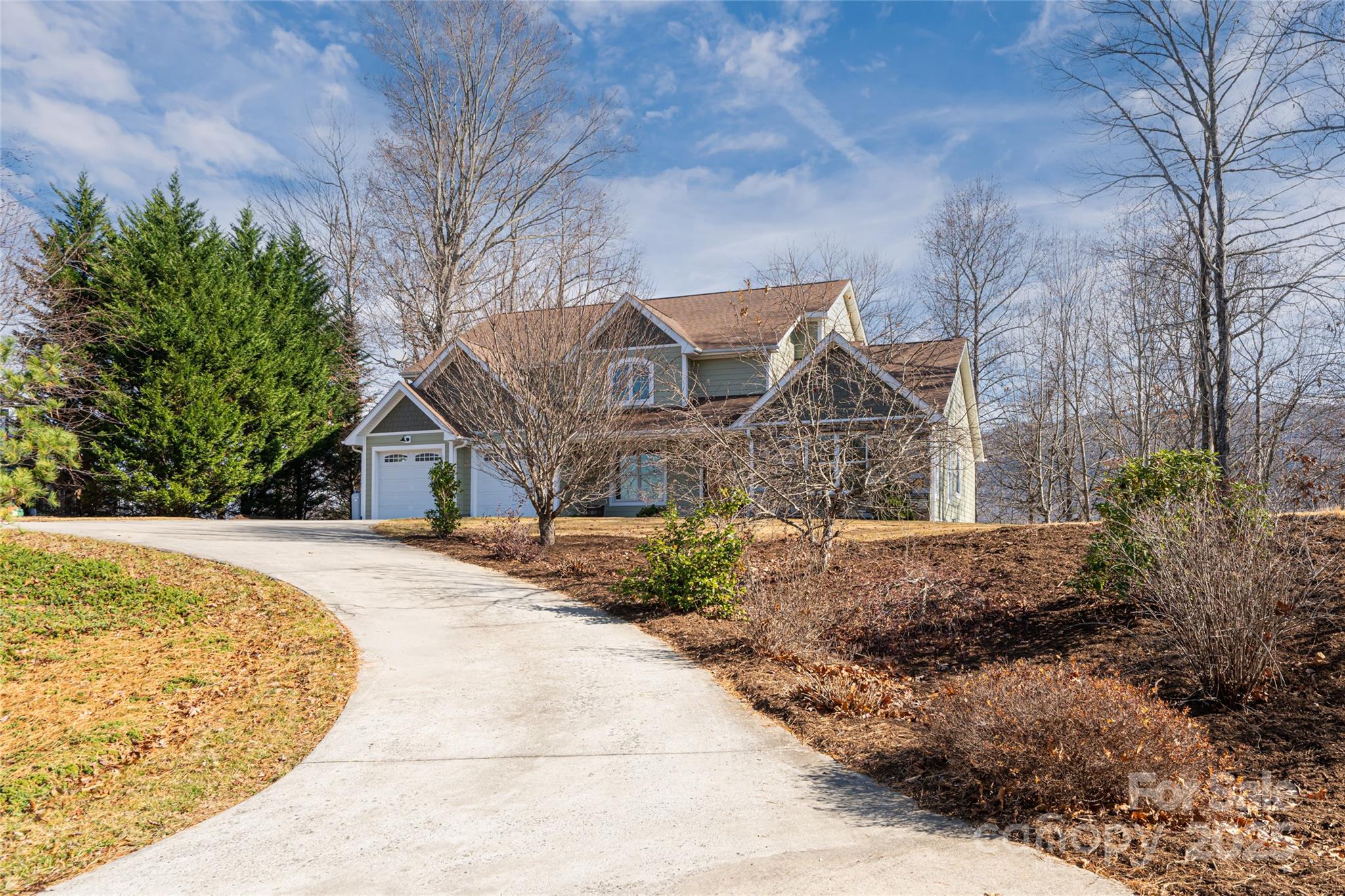 98 Sovereign Lane Fairview, NC 28730 - Photo 2 of 42 a front view of a house with a yard and garage