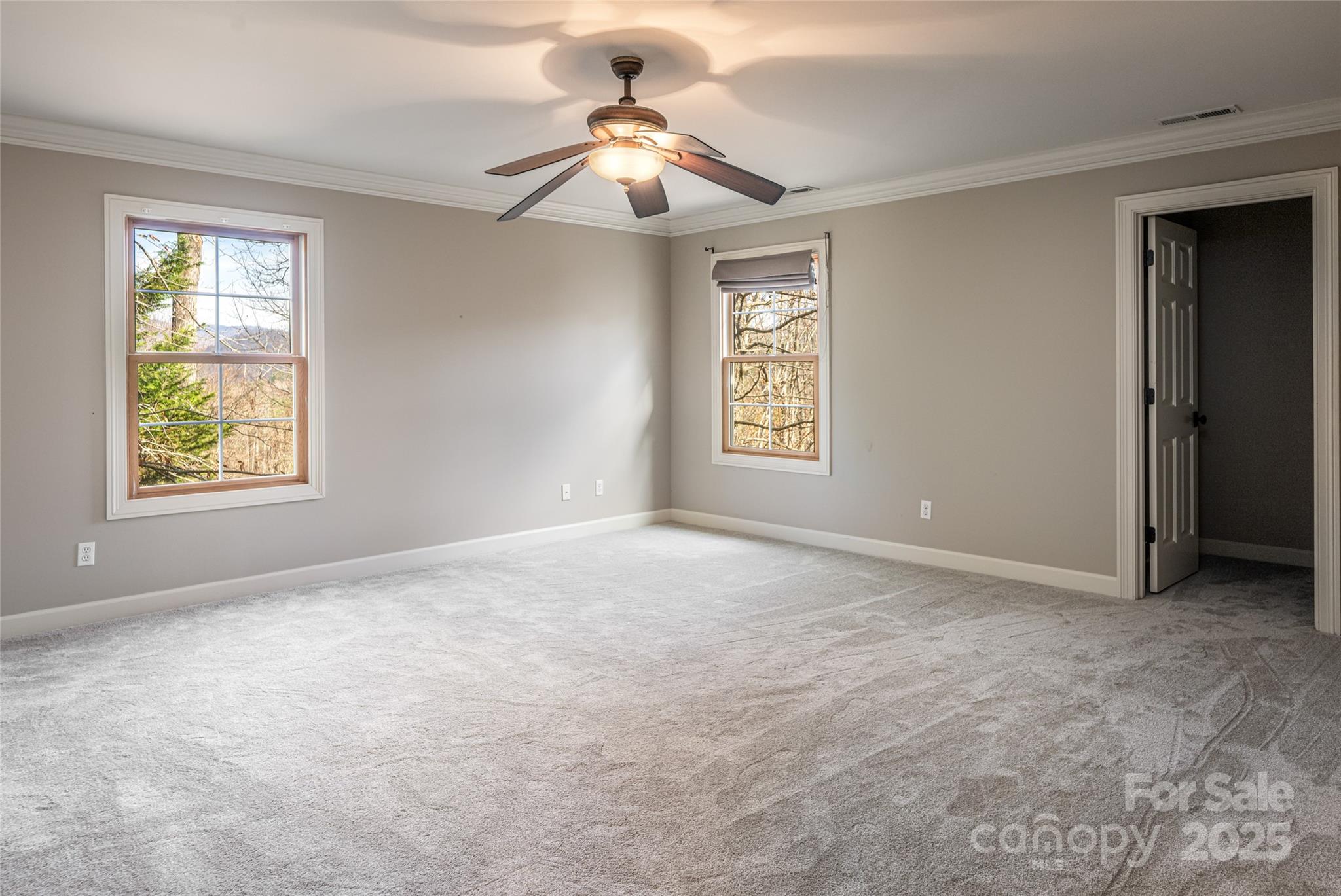 98 Sovereign Lane Fairview, NC 28730 - Photo 26 of 42 an empty room with windows and fan