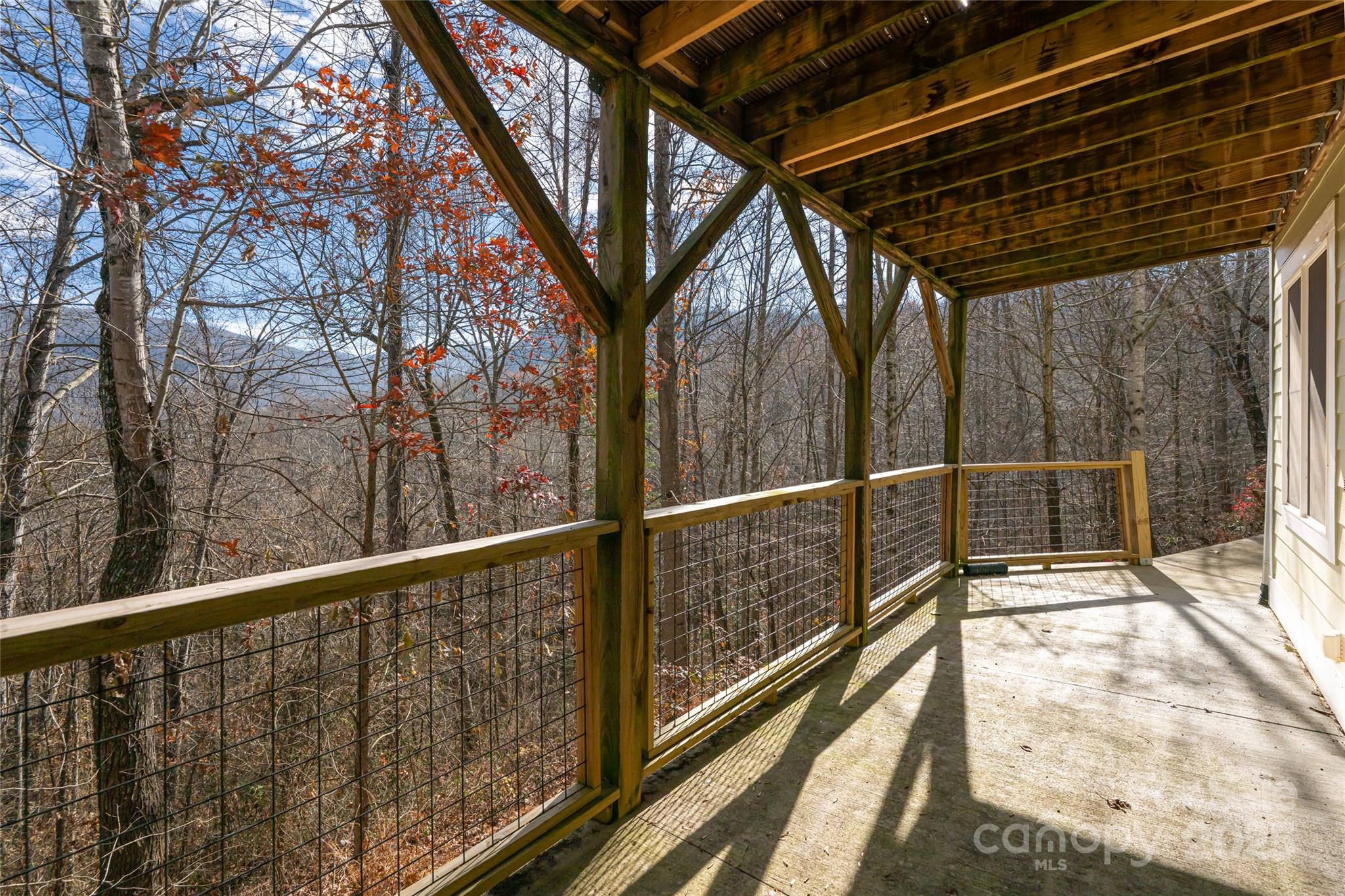 98 Sovereign Lane Fairview, NC 28730 - Photo 33 of 42 a view of balcony with wooden floor and fence