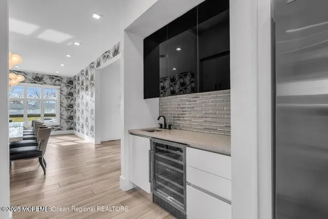a kitchen with stainless steel appliances kitchen island granite countertop a refrigerator and a sink