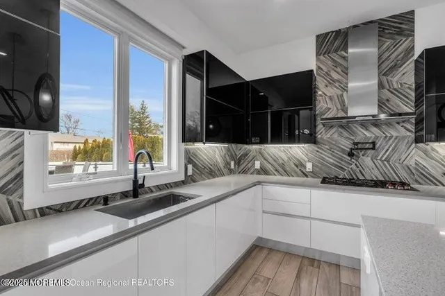 a kitchen with a sink and a large window