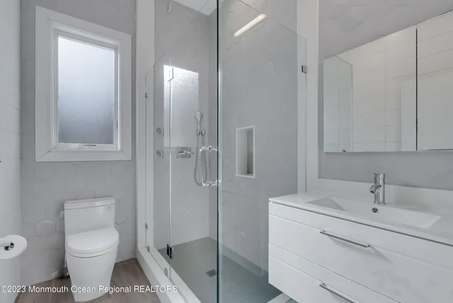 a bathroom with a toilet sink and shower
