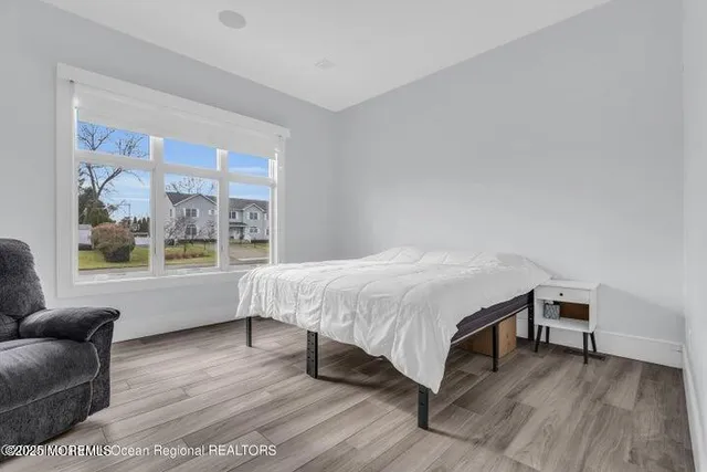 a spacious bedroom with a bed and a large window