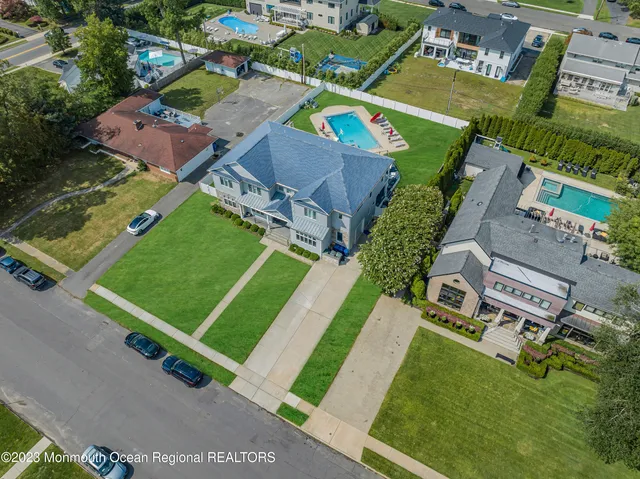 an aerial view of a tennis ground and a cars park side of the road