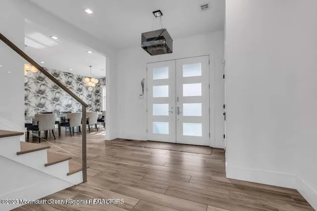 a view of a livingroom with wooden floor and stairs