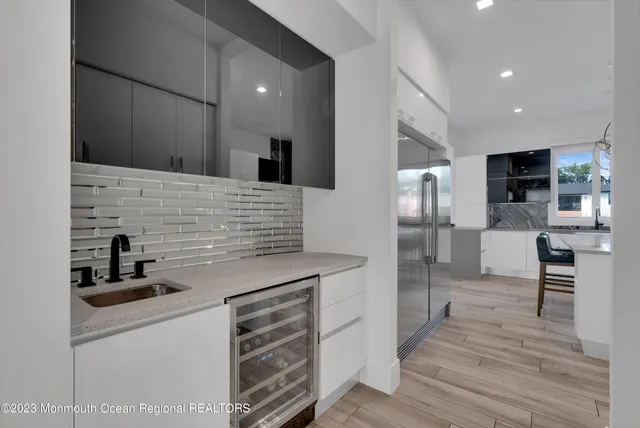 a kitchen with stainless steel appliances a refrigerator and a stove top oven