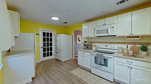 a kitchen with stainless steel appliances a stove and a refrigerator
