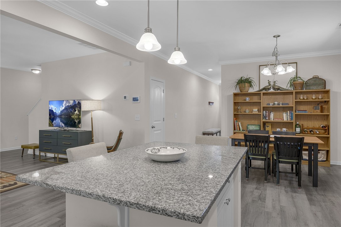 430 Johnson Road Central, SC 29630 - Photo 6 of 36 A well-lit interior space with a granite island, offering an ideal setting for both casual dining and entertaining.