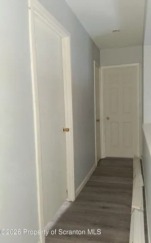 a kitchen with a refrigerator and a stove top oven
