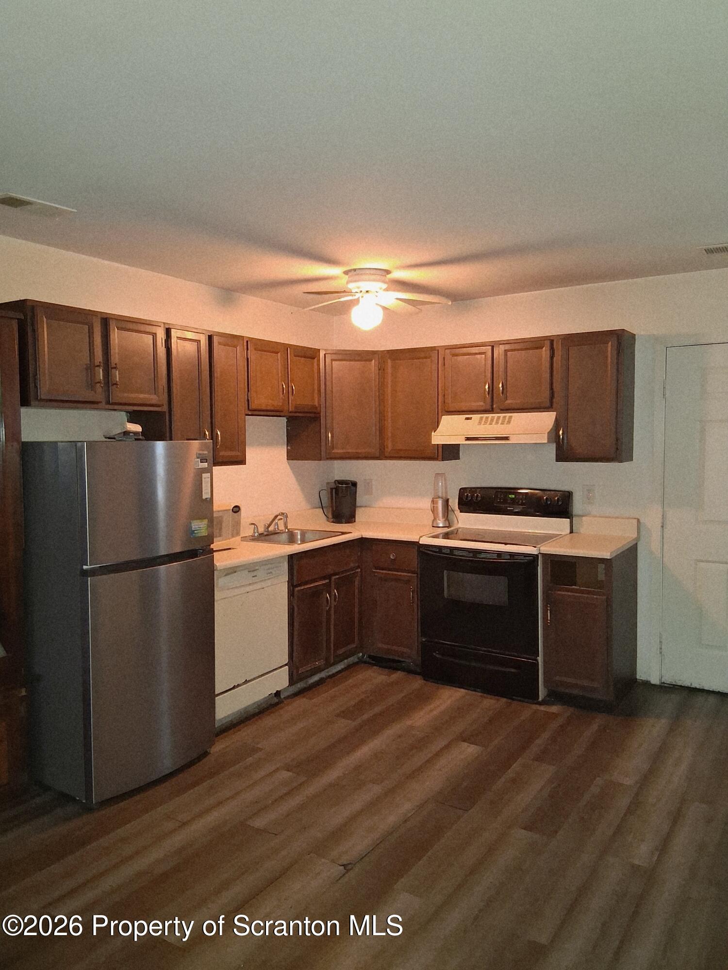 128 Meadow View Court Bushkill, PA 18324 - Photo 8 of 18 a kitchen with a refrigerator and a stove top oven