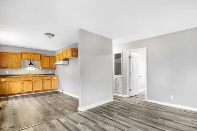 a view of a kitchen with a refrigerator a sink and dishwasher next to a window