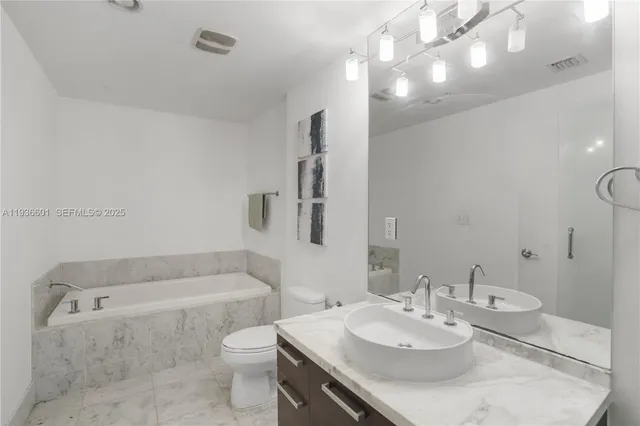 a bathroom with a sink a toilet and bathtub
