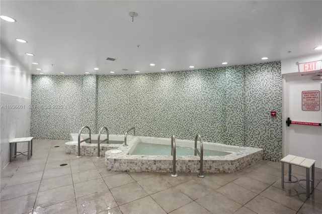 a bathroom with a tub and chandelier