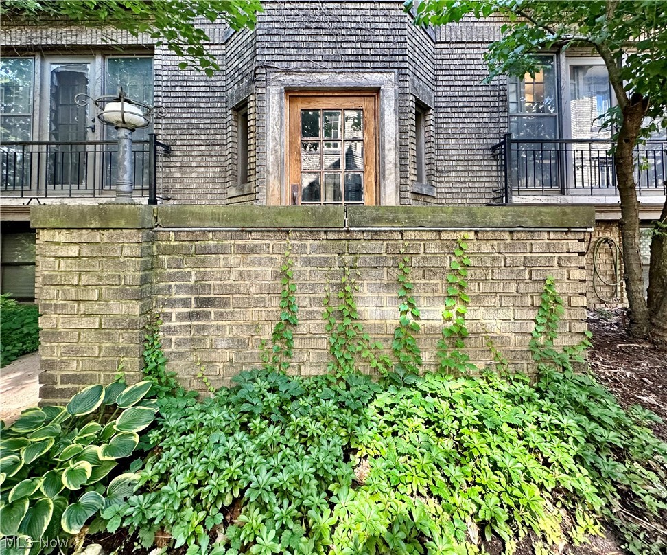 2469 Overlook Road, Unit 3 Cleveland, OH 44106 - Photo 4 of 35 Brick Front Entry surrounded by green plants, climbing Ivy and Historic Charm!