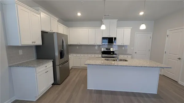 a kitchen with stainless steel appliances a refrigerator stove microwave and cabinets