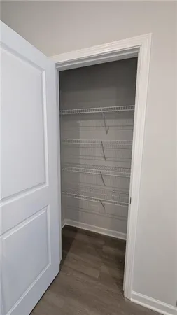 a empty closet with wooden floor