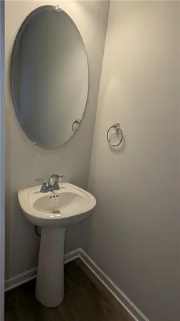 a bathroom with a sink toilet and mirror