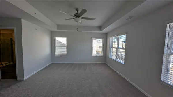 a view of a livingroom with a ceiling fan and window