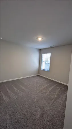 a view of an empty room and a window
