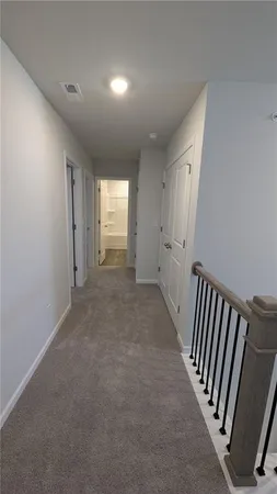 a view of a hallway with windows and stairs