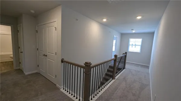 a view of entryway and hall with wooden floor