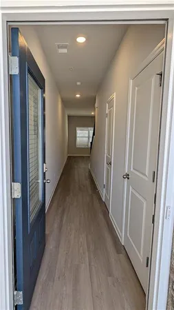 a view of a hallway with wooden floor
