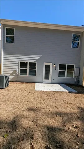 a view of house with backyard and trees