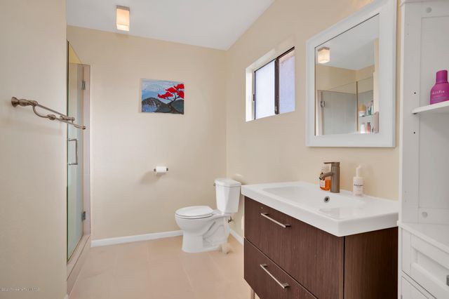 a bathroom with a sink mirror vanity and toilet