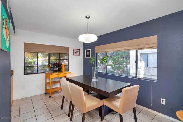 a dining room with furniture a chandelier and wooden floor