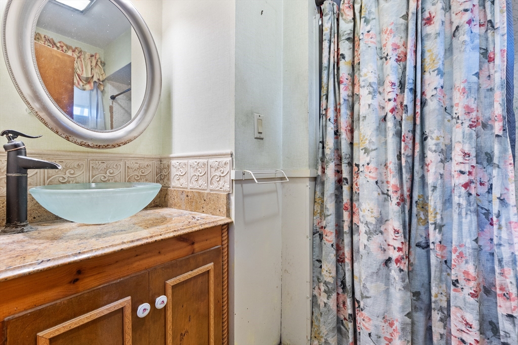 94 Gordon Road Braintree, MA 02184 - Photo 12 of 25 a bathroom with a granite countertop sink and a mirror