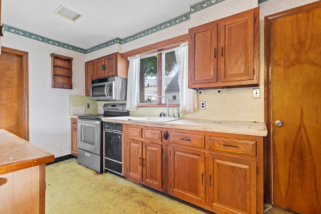 94 Gordon Road Braintree, MA 02184 - Photo 15 of 25 a kitchen with stainless steel appliances granite countertop a stove a sink dishwasher and a refrigerator