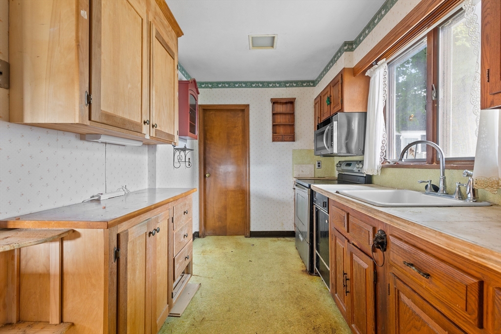 94 Gordon Road Braintree, MA 02184 - Photo 16 of 25 a kitchen with stainless steel appliances granite countertop a sink and a refrigerator
