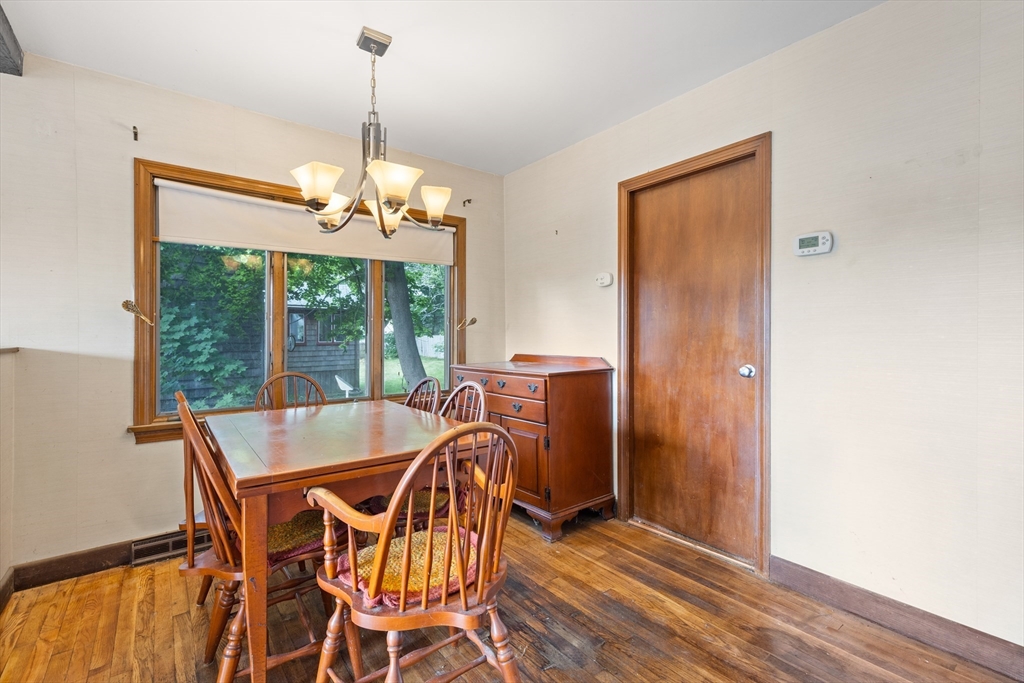 94 Gordon Road Braintree, MA 02184 - Photo 19 of 25 a dining room with furniture a chandelier and wooden floor