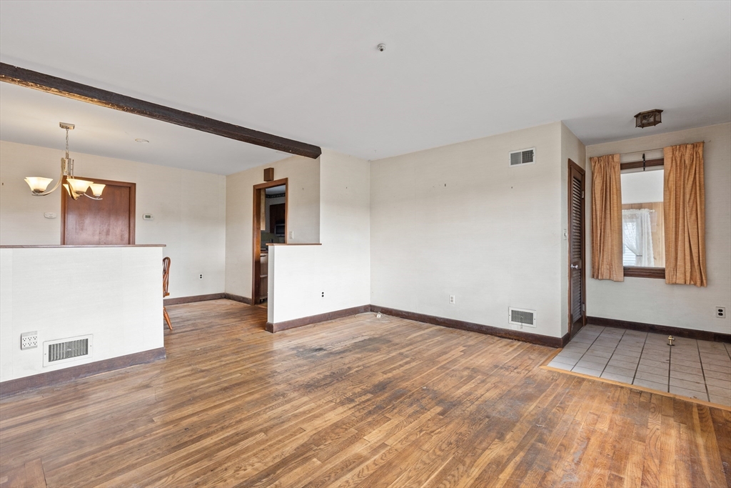94 Gordon Road Braintree, MA 02184 - Photo 20 of 25 a view of a livingroom with wooden floor and a fireplace
