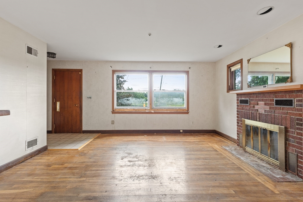94 Gordon Road Braintree, MA 02184 - Photo 22 of 25 a view of an empty room with a window and wooden floor