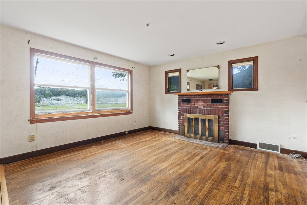 94 Gordon Road Braintree, MA 02184 - Photo 23 of 25 a view of a livingroom with a fireplace and window