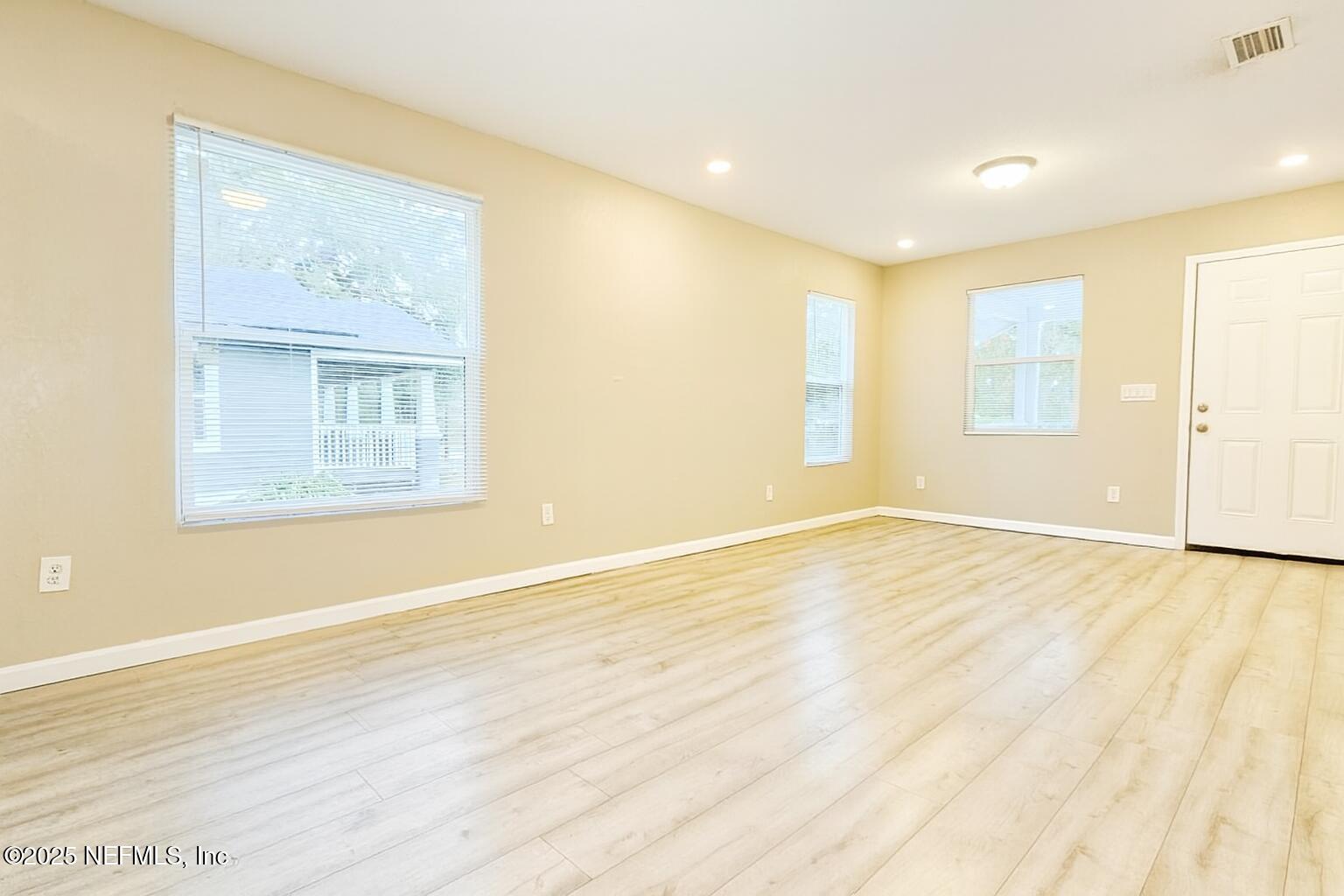 804 Westbrook Road Jacksonville, FL 32209 - Photo 13 of 23 a view of an empty room with wooden floor and a window