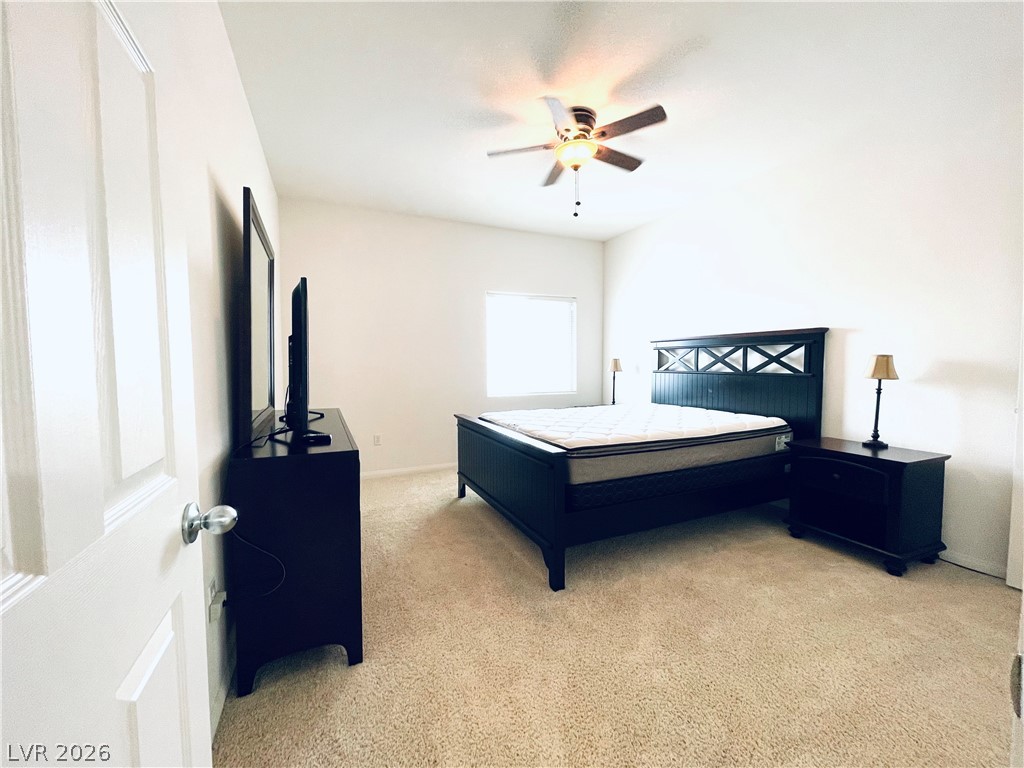 7701 West Robindale Road, Unit 206 Las Vegas, NV 89113 - Photo 21 of 30 Plush carpeting and natural light define this comfortable secondary bedroom.