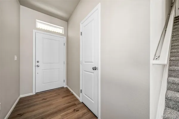 a view of a hallway with wooden floor