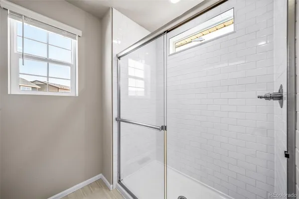 a bathroom with a glass shower door