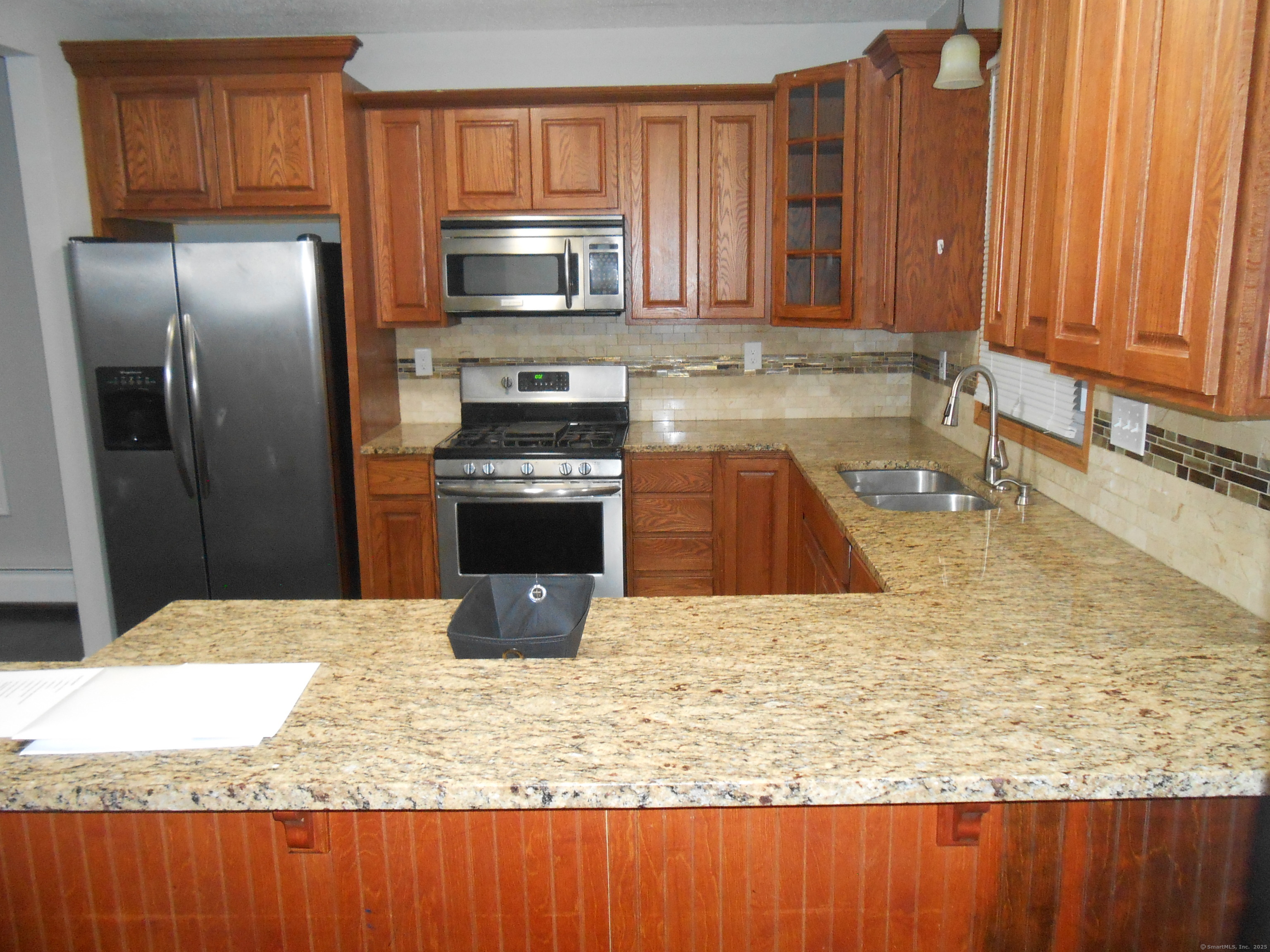 631 Whalley Avenue New Haven, CT 06511 - Photo 12 of 28 a kitchen with kitchen island granite countertop a stove a sink and a microwave